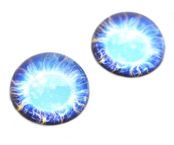 Two blue glass cabochons with a starry design on a white background