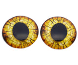 Pair of glass eyes with a cracked texture on a white background