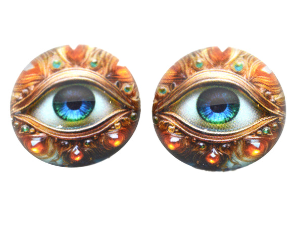 Pair of decorative eye-shaped objects with intricate designs on a white background