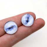 Contracted pale blue goat glass eyes