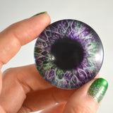 purple and green glass eye